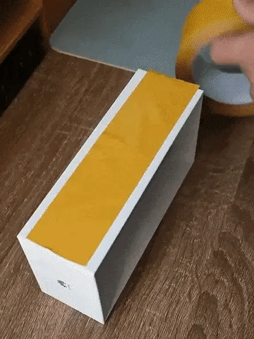 Applying double-sided tape to a small household fixture