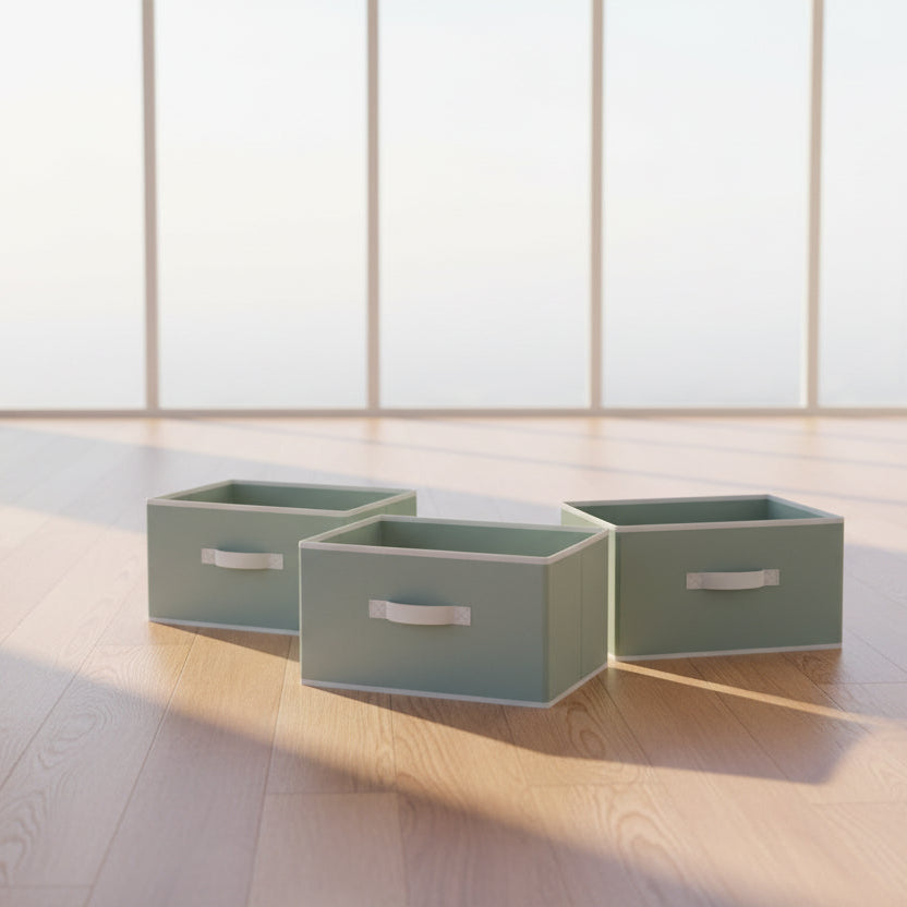 Set of four light gray storage boxes with white handles on a white background