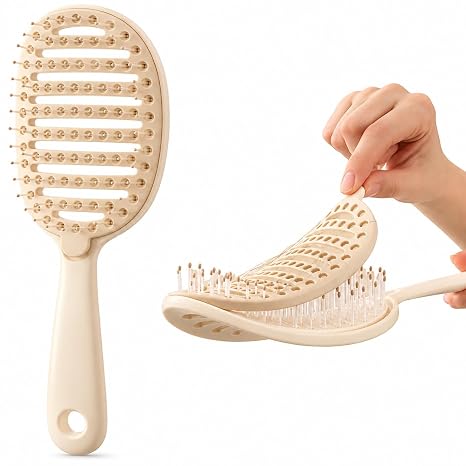 Cream vented detangling brush showing its front and removable cleaning pad